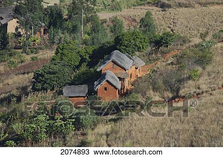 Merina Houses Along The Road Between Ambositra & Ambavalao, Fianarantsoa Province, Madagascar View Large Photo Image Stock Image - Merina Houses Along The Road Between Ambositra & Ambavalao, Fianarantsoa Province, Madagascar. Fotosearch