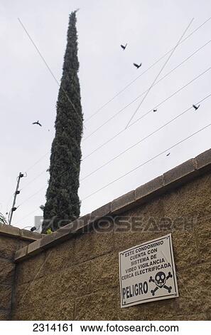 Mexico, Aguascalientes, Aguascalientes, Warning sign beneath electric fence View Large Photo Image Stock Image - Mexico, Aguascalientes, Aguascalientes, Warning sign beneath electric fence. Fotosearch