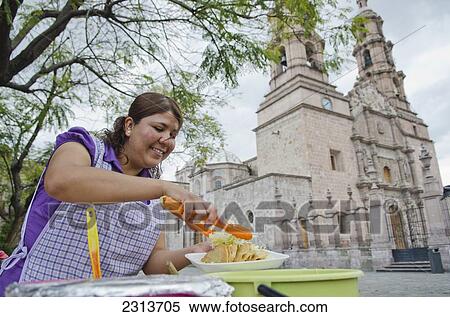 Mexico, Aguascalientes state, Aguascalientes, Street side food vendor making tacos beside old Cathedral View Large Photo Image Stock Photography - Mexico, Aguascalientes state, Aguascalientes, Street side food vendor making tacos beside old Cathedral. Fotosearch