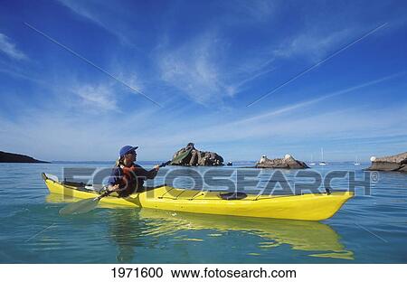 Stock Image - Mexico, Baja California Sur, Sea Of Cortez At Espiritu Santo Island Near La Paz, Woman Sea Kayaking.. Fotosearch