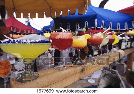 Mexico, Bar With Variety Of Blended Drinks Lined Up On Colorful Display Under Umbrellas. View Large Photo Image Stock Photo - Mexico, Bar With Variety Of Blended Drinks Lined Up On Colorful Display Under Umbrellas.. Fotosearch