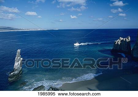 Mexico, Cabo San Lucas, Land's End, Fishing Boat On Blue Ocean Near Beach. View Large Photo Image Stock Photography - Mexico, Cabo San Lucas, Land's End, Fishing Boat On Blue Ocean Near Beach.. Fotosearch
