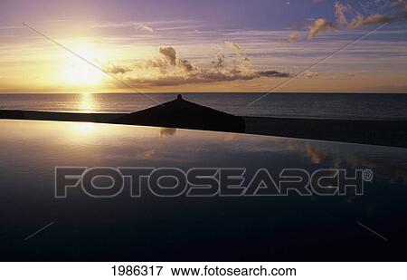 Stock Photo - Mexico, Cabo San Lucas, Las Ventanas Al Paraiso Hotel, Mirrored Swimming Pool At Sunset Overlooking Ocean.. Fotosearch