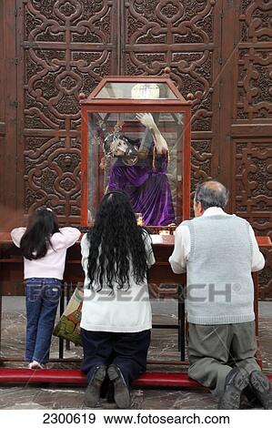 Stock Photo - Mexico, Family Praying Near Church; Mexico City. Fotosearch