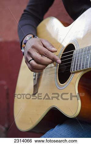Mexico, Guanajuato, Guanajuato, Female musician strumming acoustic guitar View Large Photo Image Stock Photograph - Mexico, Guanajuato, Guanajuato, Female musician strumming acoustic guitar. Fotosearch