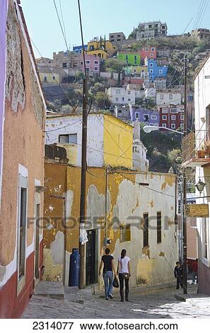 Mexico, Guanajuato, Guanajuato, People walking down street in suburban area View Large Photo Image Stock Photo - Mexico, Guanajuato, Guanajuato, People walking down street in suburban area. Fotosearch