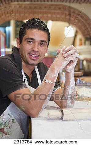 Picture - Mexico, Guanajuato State, Guanajuato, Portrait of Young male baker. Fotosearch