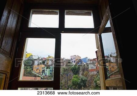 Mexico, Guanajuato State, Guanajuato, Looking through old wooden window at hillside scene of old Spanish homes View Large Photo Image Stock Photo - Mexico, Guanajuato State, Guanajuato, Looking through old wooden window at hillside scene of old Spanish homes. Fotosearch
