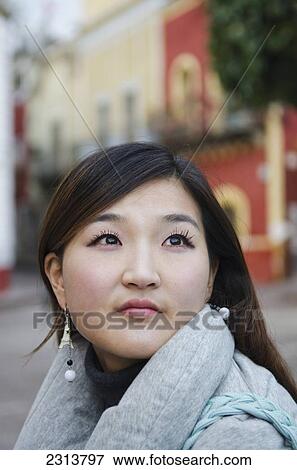 Stock Photo - Mexico, Guanajuato State, Guanajuato, Young Korean woman with old Spanish buildings in background. Fotosearch