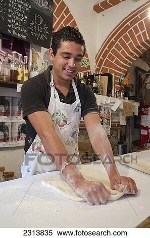 Mexico, Guanajuato State, Guanajuato, Young male baker making pizza dough View Large Photo Image Stock Photography - Mexico, Guanajuato State, Guanajuato, Young male baker making pizza dough. Fotosearch