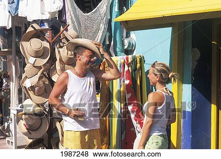 Stock Photo - Mexico, Isla Mujeres, Couple Shopping, Local Storefronts.. Fotosearch
