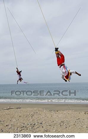 Stock Photo - Mexico, Jalisco, Puerta Vallarta, Acrobats performing on beach. Fotosearch