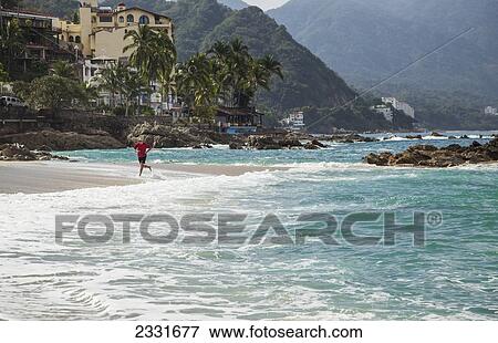 Mexico, Man running along Conchas Chinas beach; Puerto Vallarta View Large Photo Image Stock Photo - Mexico, Man running along Conchas Chinas beach; Puerto Vallarta. Fotosearch