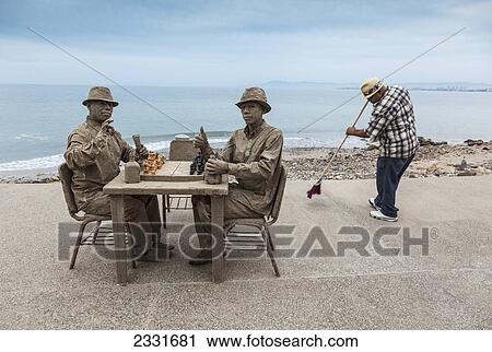 Stock Image - Mexico, Puerto Vallarta, Buskers imitating sand statues at beachfront; Malecon. Fotosearch