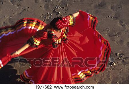 Stock Image - Mexico, View From Above Of Woman In Red Dress Dancing On Sand.. Fotosearch