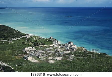 Stock Photograph - Mexico, Yucatan Peninsula, Aerial view of Mayan Ruins along beautiful ocean's coastline; Tulum. Fotosearch