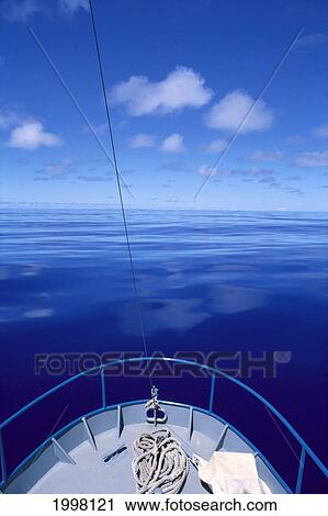 Stock Image - Micronesia, Bow Of Boat Overlooking Calm Ocean With Reflections A60C. Fotosearch