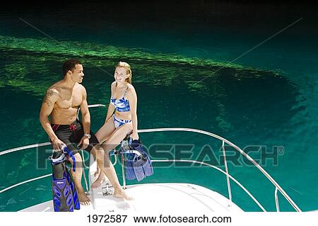 Stock Photo - Micronesia, Palau, Divers With Snorkel Equipment About To Enter The Water Off A Boat.. Fotosearch