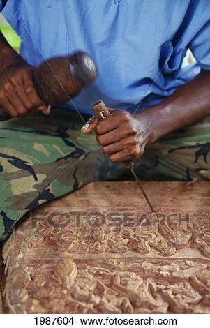 Picture - Micronesia, Palau, Local Mans Hands Carving Wooden Story Board. Fotosearch