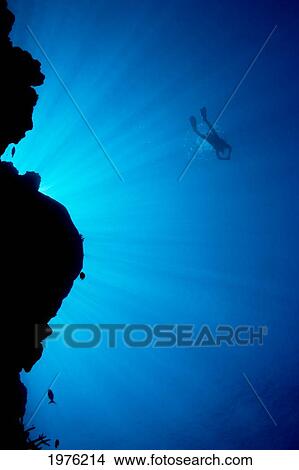 Micronesia, Yap, Light Rays Shining Through Reef Canyon, Diver In Distance. View Large Photo Image Picture - Micronesia, Yap, Light Rays Shining Through Reef Canyon, Diver In Distance.. Fotosearch