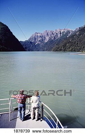 Stock Photo - Middle Aged Couple On A Boat On A Lake. Fotosearch