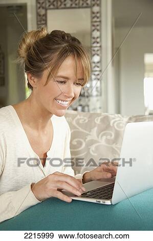 Middle aged woman using her laptop. View Large Photo Image Stock Photo - Middle aged woman using her laptop.. Fotosearch