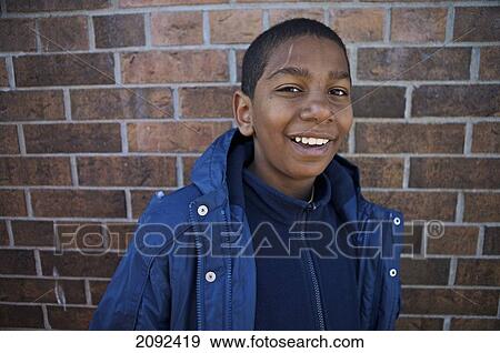 Stock Photo - Middle Eastern Boy Against Brick Wall Of An Esl School; Guelph Ontario Canada. Fotosearch