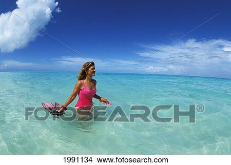 Midway Atoll, Woman In Pink Stands In Clear Aqua Water With Snorkel Gear, Smiling View Large Photo Image Picture - Midway Atoll, Woman In Pink Stands In Clear Aqua Water With Snorkel Gear, Smiling. Fotosearch