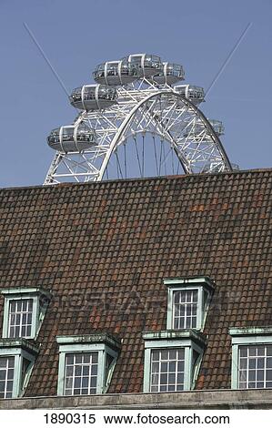 Stock Photography - Millenium Wheel Behind Rooftop. Fotosearch