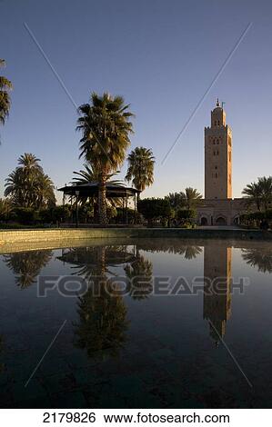 Stock Photograph - Minaret of the Koutoubia Mosque reflected in a fountain at dawn; Marrakesh, Morocco. Fotosearch