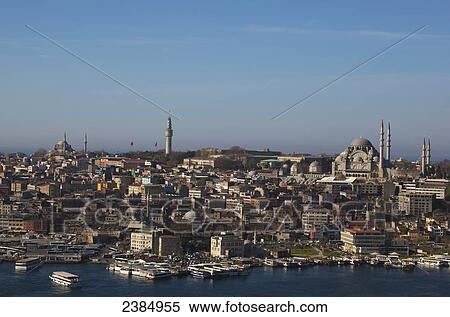 Stock Photography - Minarets of islamic mosques against a blue sky and the waterfront along the Bosphorus; Istanbul, Turkey. Fotosearch