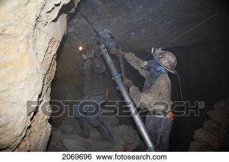 Miners Drilling Holes To Place Dynamite Into The Rock With A Compressed Air Pneumatic Drills In A Shaft Of The Cerro Rico De Potos View Large Photo Image Stock Photograph - Miners Drilling Holes To Place Dynamite Into The Rock With A Compressed Air Pneumatic Drills In A Shaft Of The Cerro Rico De Potos. Fotosearch