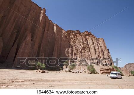 Picture - Minivan in front of the La Catedral (The Cathedral) Formation, Talampaya National Park, La Rioja, Argentina. Fotosearch