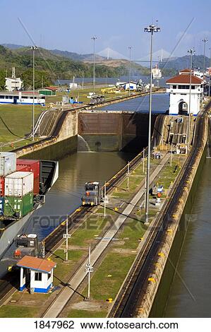 Stock Image - Miraflores Locks, Panama Canal, Panama, Central America; Container Ship In Lock. Fotosearch