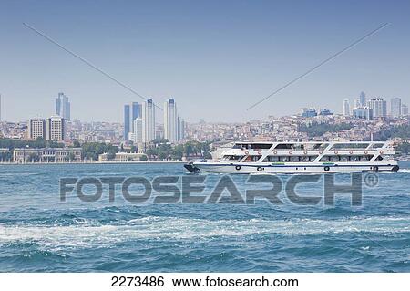 Modern buildings on the city skyline behind the dolmabahce palace with the bosphorus ferry in foreground; istanbul turkey View Large Photo Image Stock Photograph - Modern buildings on the city skyline behind the dolmabahce palace with the bosphorus ferry in foreground; istanbul turkey. Fotosearch