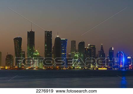 Stock Photo - Modern city skyline at dusk; Doha, Qatar. Fotosearch