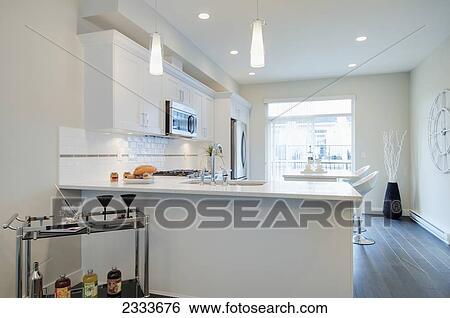 Modern Kitchen With Breakfast Bar And Bar Cart; Surrey, British Columbia, Canada View Large Photo Image Stock Photograph - Modern Kitchen With Breakfast Bar And Bar Cart; Surrey, British Columbia, Canada. Fotosearch