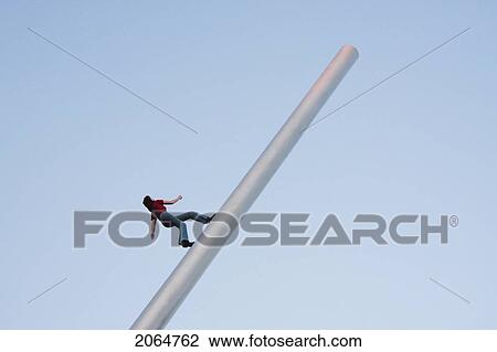 Stock Image - Modern Sculpture Of A Woman Climbing To The Top, Strasbourg, France. Fotosearch