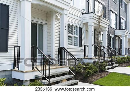 Stock Photograph - Modern Townhouse Row Exterior With Sidewalks And Porches; Surrey, British Columbia, Canada. Fotosearch