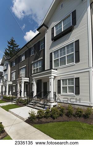 Stock Photography - Modern Townhouse Row Exterior With Sidewalks; Surrey, British Columbia, Canada. Fotosearch