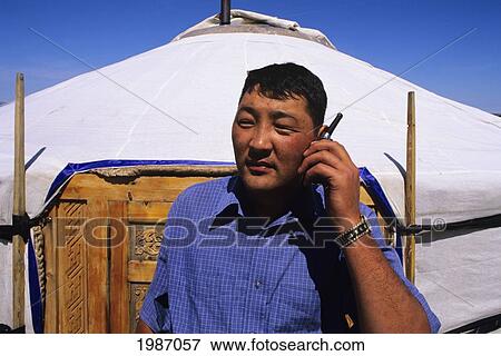 Stock Photo - Mongolia, Ger Ranch, Nomadic Community, Local Man On Cell Phone.. Fotosearch