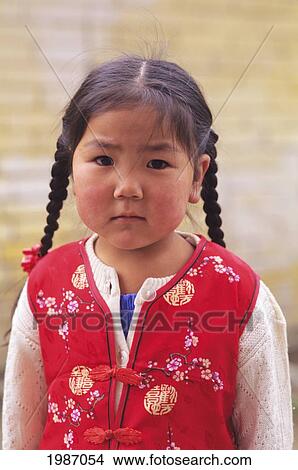 Picture - Mongolia, Girl wearing red vest; Ulaanbaatar. Fotosearch