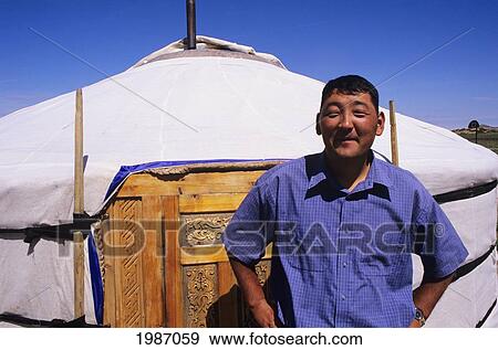 Mongolia, Nomadic Community; Ger Ranch, Local man standing in front of unique house View Large Photo Image Stock Photo - Mongolia, Nomadic Community; Ger Ranch, Local man standing in front of unique house. Fotosearch