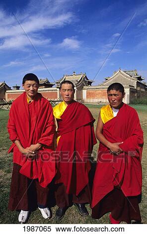 Stock Photography - Mongolia, Religious Buddhist Center, Erdene Zuu Monastery, Three Young Monks Wearing Colorful Red Robes.. Fotosearch