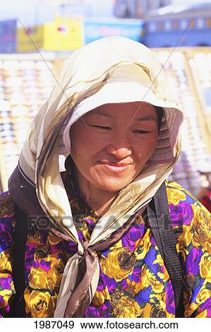 Stock Photo - Mongolia, Woman wearing scarf in bright sunlight; Ulaanbaatar. Fotosearch