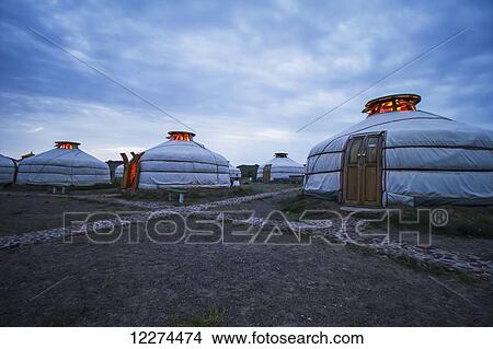 Picture - Mongolian Gers (yurts) tourist accommodation at the Ongiin Nuts Ger Camp at dusk, Saikhan-Ovoo, Dundgovi Province, Mongolia. Fotosearch