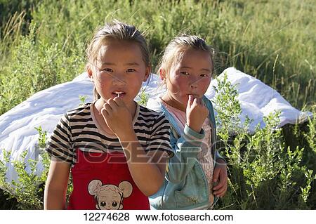Stock Photo - Mongolian girls with lollypops, Khogno Khan Uul Nature Reserve, Arkhangai Province, Mongolia. Fotosearch