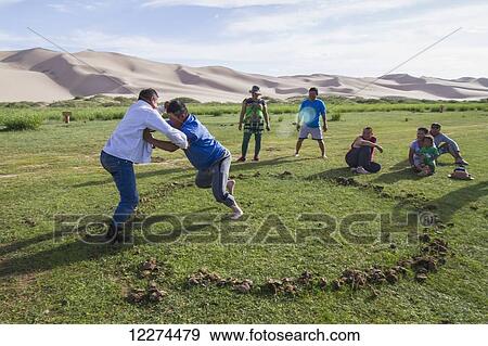 Mongolian men wrestling in Seruun Bulag oasis by the sand dunes of Khongoryn Els, Gobi Gurvansaikhan National Park,? mn÷govi Province, Mongolia View Large Photo Image Stock Photo - Mongolian men wrestling in Seruun Bulag oasis by the sand dunes of Khongoryn Els, Gobi Gurvansaikhan National Park,? mn÷govi Province, Mongolia. Fotosearch
