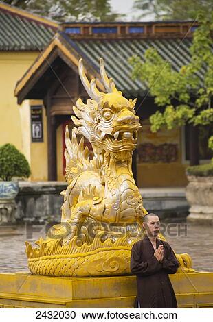 Stock Image - Monk praying at the Imperial Citadel; Hue, Vietnam. Fotosearch