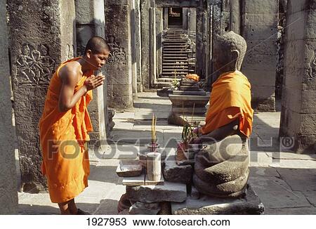 Stock Image - Monk Praying In The Preah Khan Temple. Fotosearch